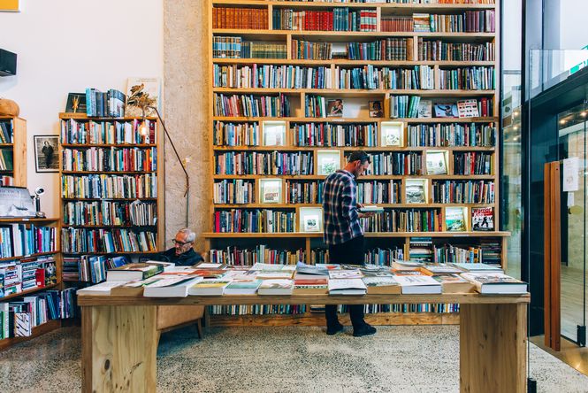 A man browsing books inside Browsers Bookshop in Hamilton.