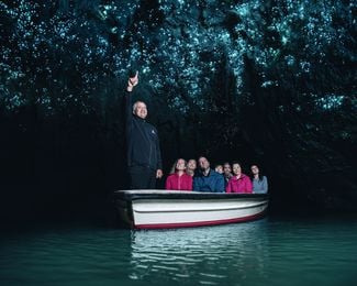 People in a boat in a cave.